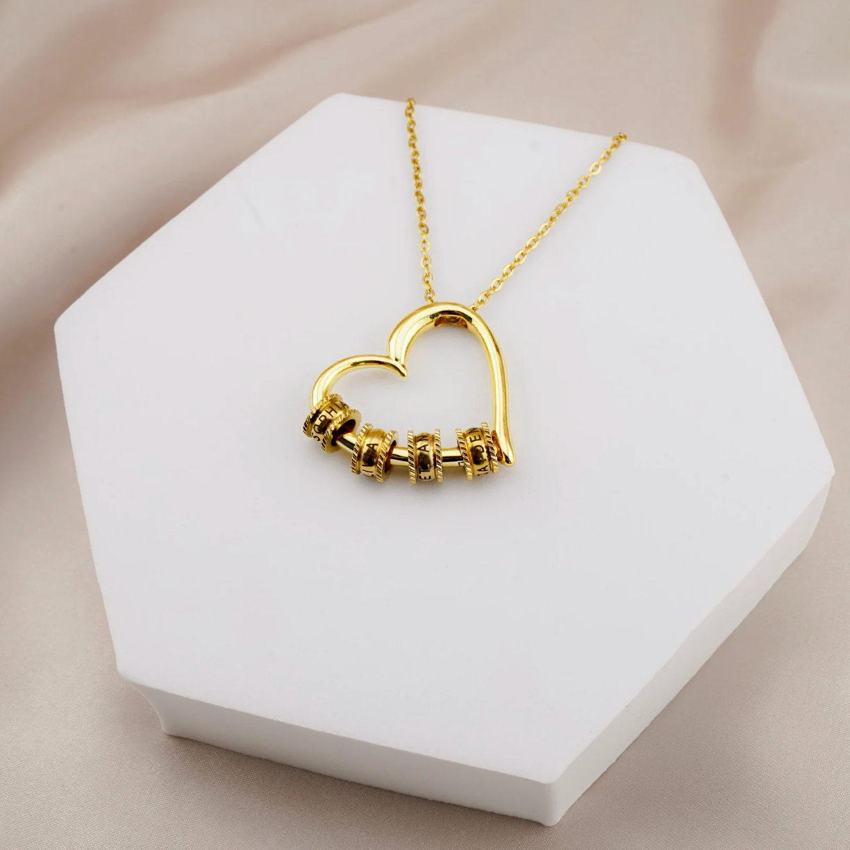 Custom engraved name beads close up - gold finish BondBeads